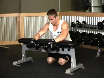 Correct form for the Palms-Down Dumbbell Wrist Curl Over A Bench