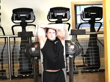 Correct form for the Standing Low-Pulley One-Arm Triceps Extension
