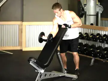 Correct form for the Standing One-Arm Dumbbell Curl Over Incline Bench